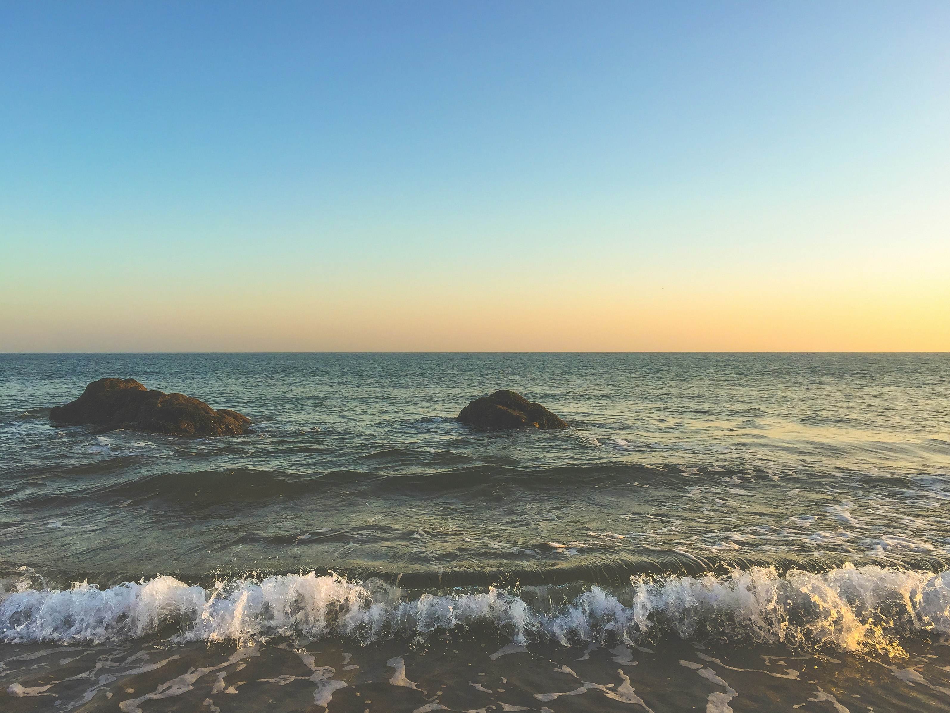 photo of waves crushing on seashore